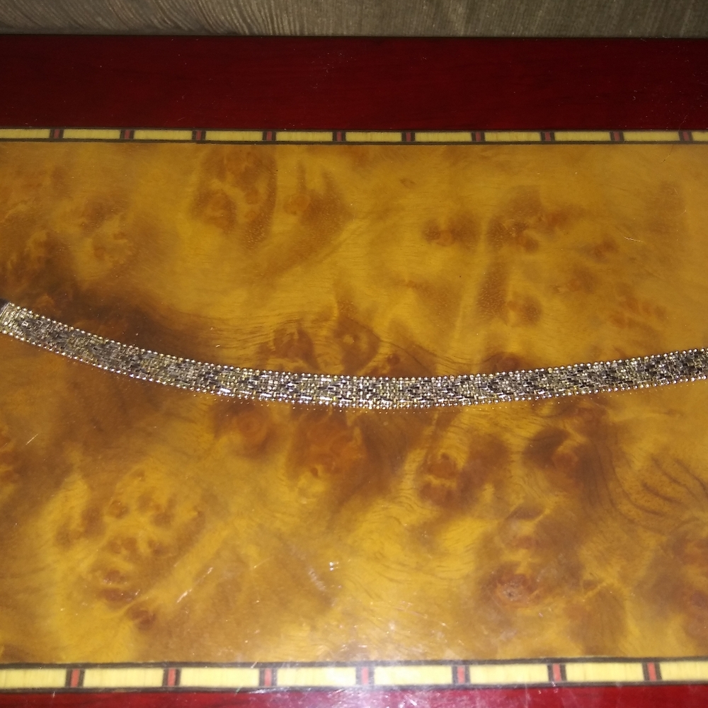 Herringbone pattern G E bracelet over silver